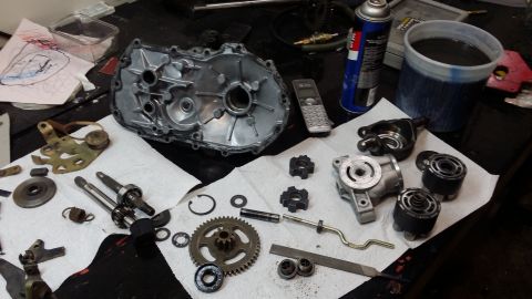 2007 Subaru Impreza - Various engine components, including a transmission case and gears, are disassembled and arranged on a workbench.