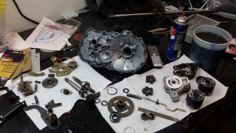 2007 Subaru Impreza - Various transmission or gearbox parts are spread out on a workbench, suggesting a repair or rebuild process.