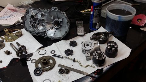 2007 Subaru Impreza - Various transmission components are laid out on a workbench, suggesting a repair or rebuild process is underway.