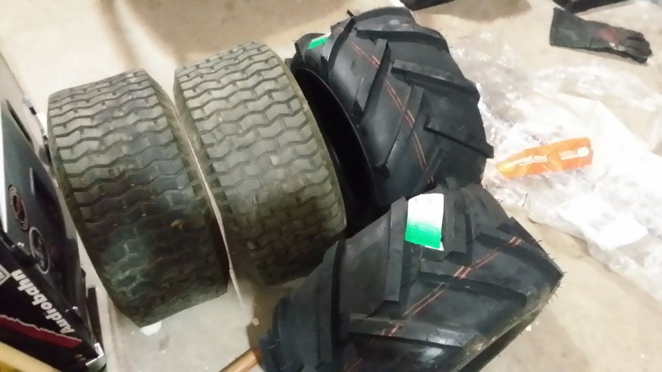 Two used lawnmower tires and two new tractor tires