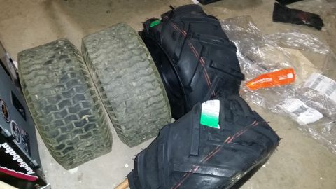2007 Subaru Impreza - A collection of lawn tractor tires, some new and some used, are piled on the floor.