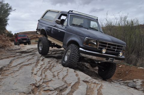 1991 Ford Bronco - Off-roading adventure in Moab with a 1991 Ford Bronco and a Jeep on a challenging rocky path.