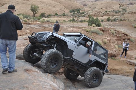 1991 Ford Bronco - A Jeep Wrangler navigates a challenging off-road course in a desert landscape.
