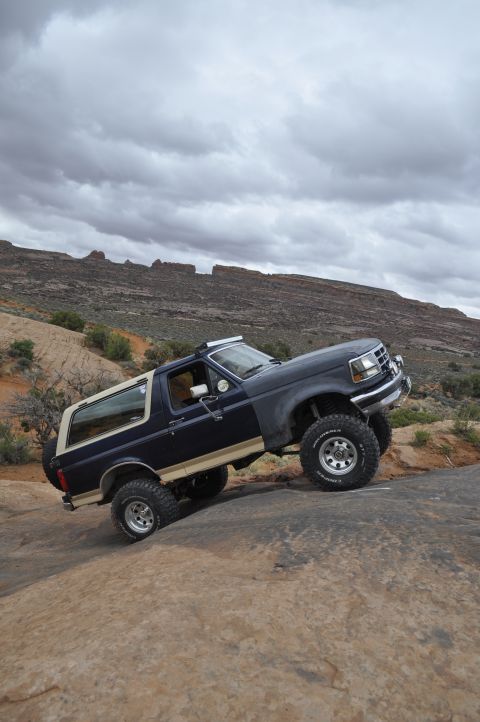 1991 Ford Bronco - Ford Bronco navigates a challenging rocky terrain off-road.