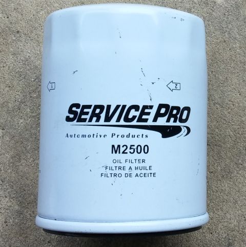 2000 Ford Crown Victoria - A white Service Pro M2500 oil filter is shown against a concrete background.