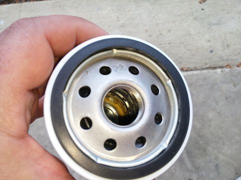 2000 Ford Crown Victoria - Close-up of an oil filter, showing the threaded interior and mounting holes.