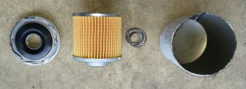 2000 Ford Crown Victoria - Disassembled oil filter components laid out on a concrete surface.