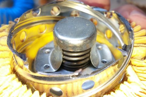 2000 Ford Crown Victoria - Close-up view of an oil filter's internal components, showing a yellow filter element and a central spring mechanism.