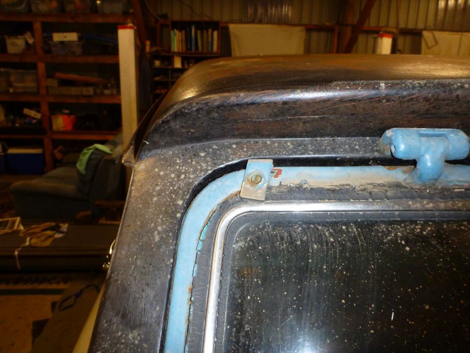 Close-up of a car's roof edge and window frame with blue trim