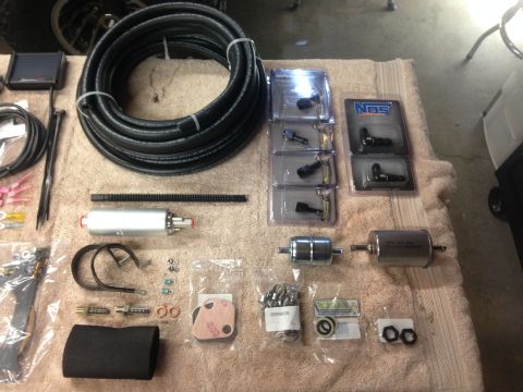 1979 Ford Bronco - Various automotive fuel system components are arranged for installation.