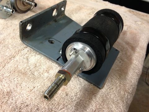 1979 Ford Bronco - A close-up view of a fuel pump assembly mounted on a bracket, resting on a towel.