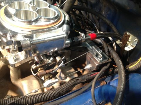 1979 Ford Bronco - Engine bay detail showing a carburetor and throttle linkage installation.