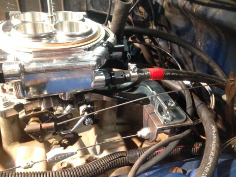 1979 Ford Bronco - This image shows a close-up view of a vehicle's engine, focusing on the carburetor and fuel lines.