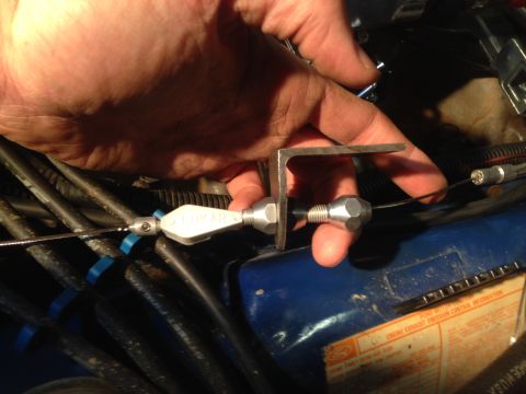 1979 Ford Bronco - Installing a throttle cable bracket on a 1979 Ford Bronco engine, part of a Holley Sniper installation.