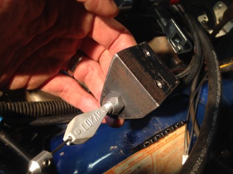 1979 Ford Bronco - Installing a Lokar throttle cable bracket on an engine component.