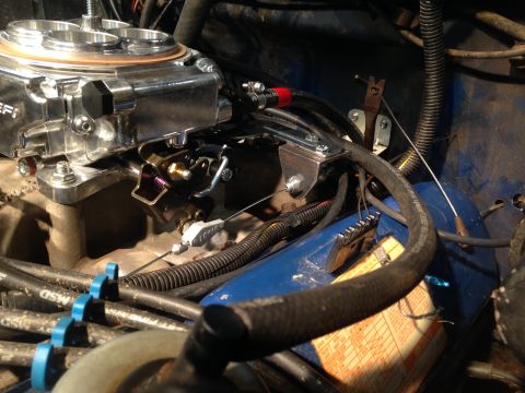1979 Ford Bronco - Close-up view of a Holley Sniper EFI throttle body installation, showing the linkage and associated engine components.
