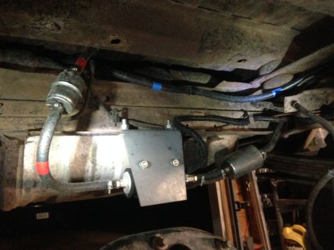 1979 Ford Bronco - Underside view of fuel system components, including filters and a pump, installed on a vehicle.