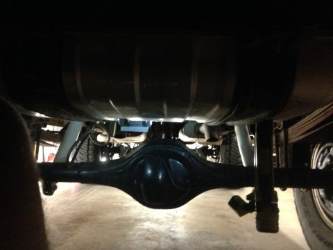 1979 Ford Bronco - Underside view of a vehicle's rear axle and fuel tank, with visible suspension parts.