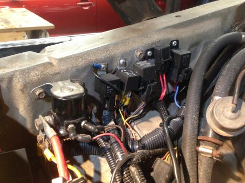 1979 Ford Bronco - Close-up view of the electrical relays and wiring in a vehicle's engine compartment.