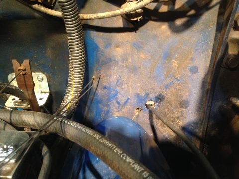 1979 Ford Bronco - Close-up view of engine bay components, including hoses and wiring, with visible text on a hose.
