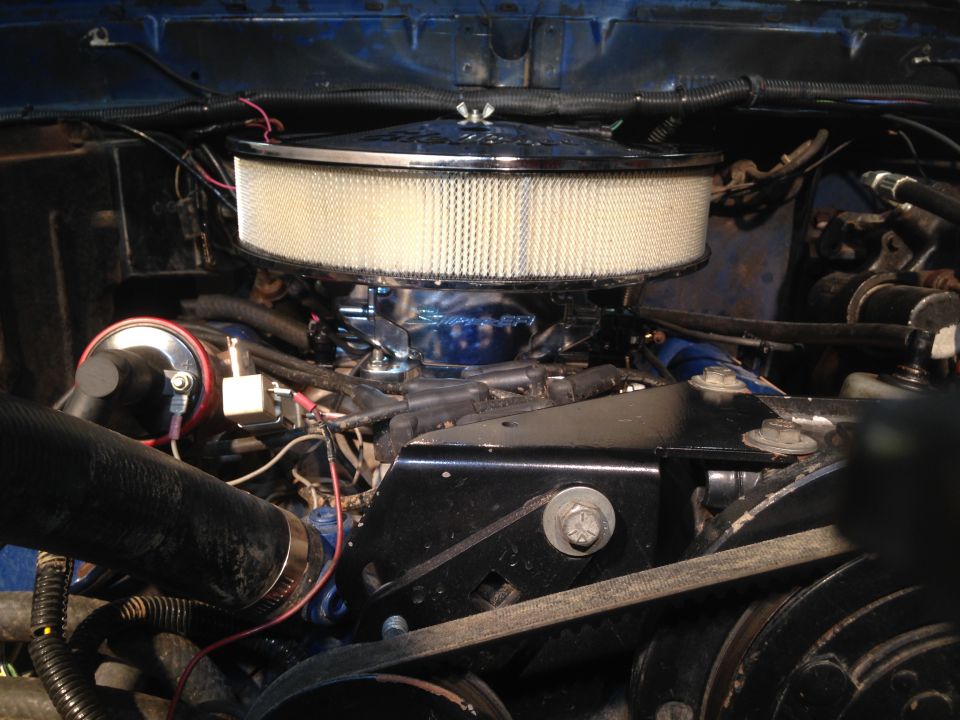Engine bay with large chrome air filter housing and blue engine components