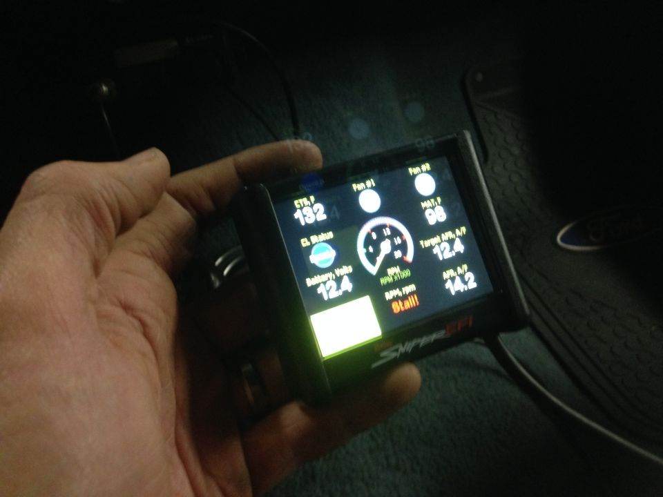 Digital gauge display showing engine data like RPM, battery voltage, and temperature