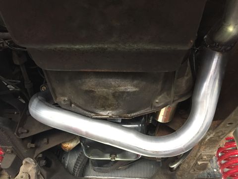 1979 Ford Bronco - Custom exhaust pipe installation on a vehicle, showing the transmission and suspension components.
