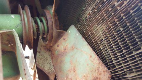 1973 Ford F-100 - Close-up view of a radiator fan and pulley system, showing signs of rust and wear.