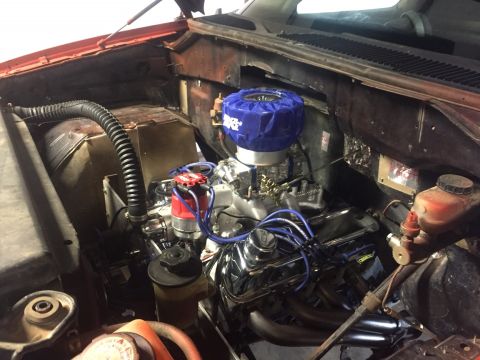 1982 Ford Bronco - Close-up view of a V8 engine bay, chrome valve covers and a blue air filter cover.