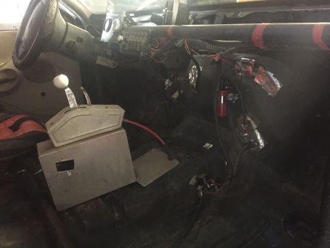 1982 Ford Bronco - Custom interior with racing shifter and roll cage visible, wiring is exposed.