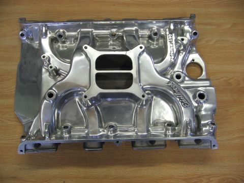 1968 Mercury Cougar - Polished aluminum Edelbrock Performer 390 intake manifold shown on a wooden surface.
