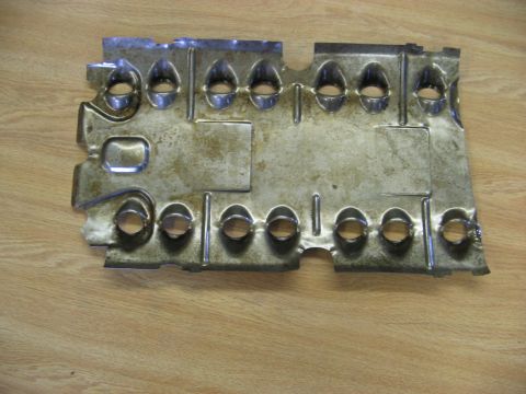 1968 Mercury Cougar - This is a metal heat shield with numerous stamped holes, likely for an automotive application.