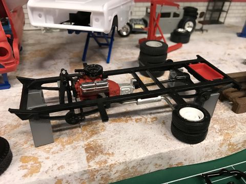 1989 Ford Bronco - Model car chassis assembly with engine and wheels, part of a larger build.
