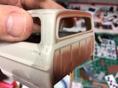 1989 Ford Bronco - A close-up view of an unfinished model truck cab, showing primer on the rear section.