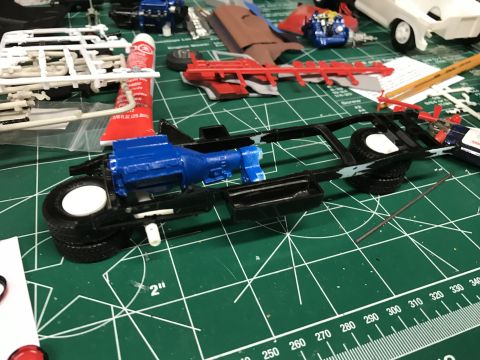 1989 Ford Bronco - Model car chassis assembly in progress, showing engine and drivetrain components.