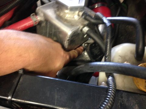 2015 Subaru Impreza - Close-up view of an engine component with a hand indicating a specific area.