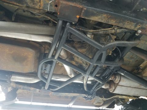 1988 Ford Bronco - Custom roll cage and exhaust system visible on the undercarriage of a vehicle.