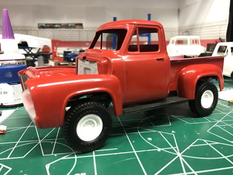 1989 Ford Bronco - Unfinished model truck kit on a cutting mat, with a bottle of glue nearby.