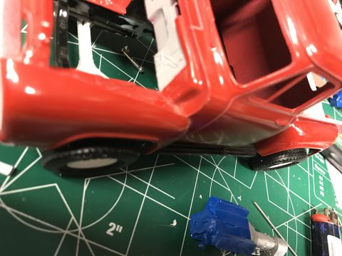 1989 Ford Bronco - Model car assembly in progress, showing chassis, body, and separate engine block.