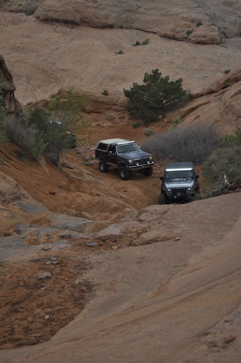 1991 Ford Bronco - A 1991 Ford Bronco navigates a rocky off-road trail in Moab, Utah, followed by a Jeep.