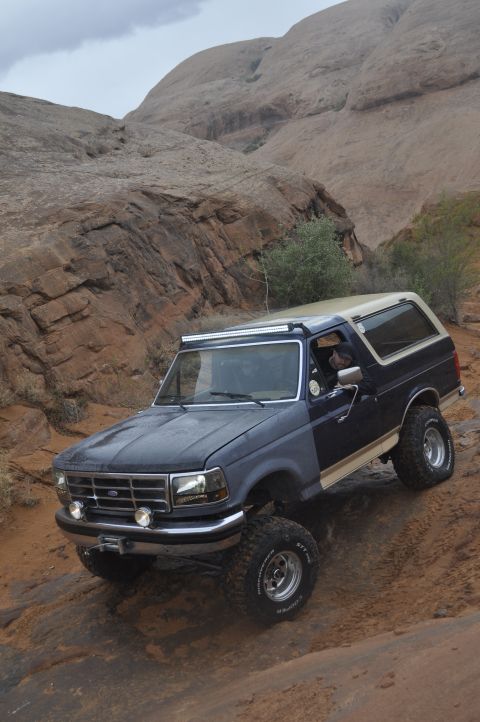 1991 Ford Bronco - This 1991 Ford Bronco navigates a challenging off-road course with its distinctive two-tone paint and lifted stance.