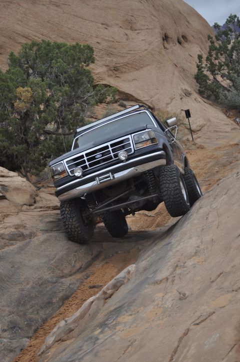 1991 Ford Bronco - This Ford Bronco navigates a challenging rocky trail, appearing to be a 1992 model.
