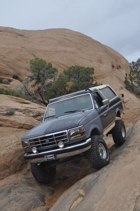 1991 Ford Bronco - 1991 Ford Bronco navigating a rocky trail in Moab.