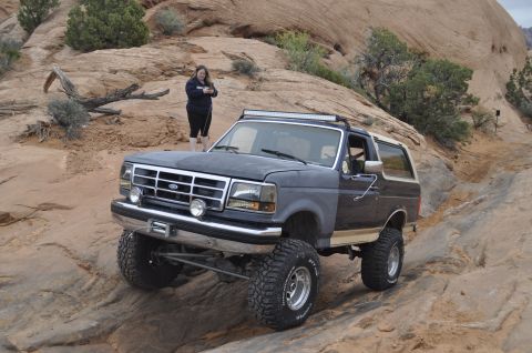 1991 Ford Bronco - This 1991 Ford Bronco is tackling a challenging off-road course in a desert landscape.