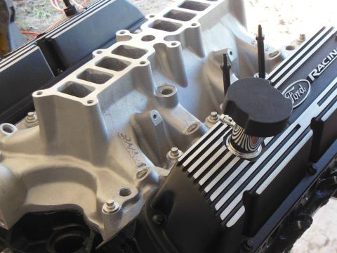 1984 Ford Bronco - Engine components, including valve covers with 'Ford Racing' text, are shown in detail.