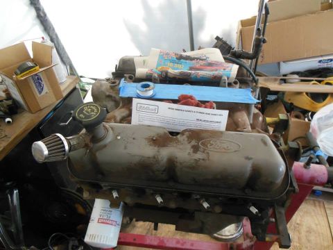 1984 Ford Bronco - A Ford V8 engine is shown on a stand, with installation instructions and an oil filter nearby.