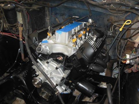 1984 Ford Bronco - Engine bay with a newly installed engine, showing fuel injectors and wiring harnesses.