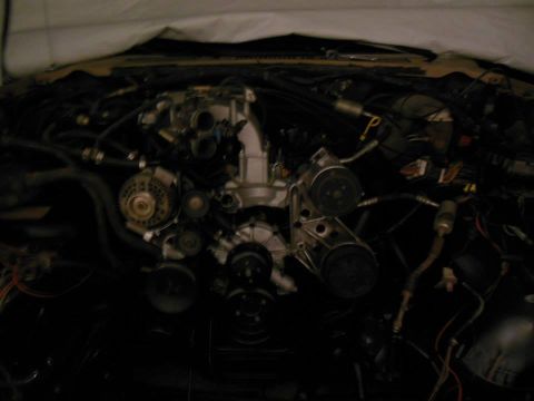 1984 Ford Bronco - Close-up view of an engine bay, showing mechanical parts and electrical connections.