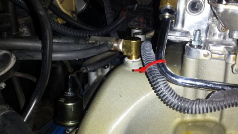 1976 Ford Ranchero - Engine intake manifold with fuel lines and a fuel filter attached.