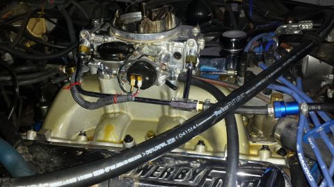 1976 Ford Ranchero - This image shows a close-up view of an engine's intake system, including a carburetor and manifold.